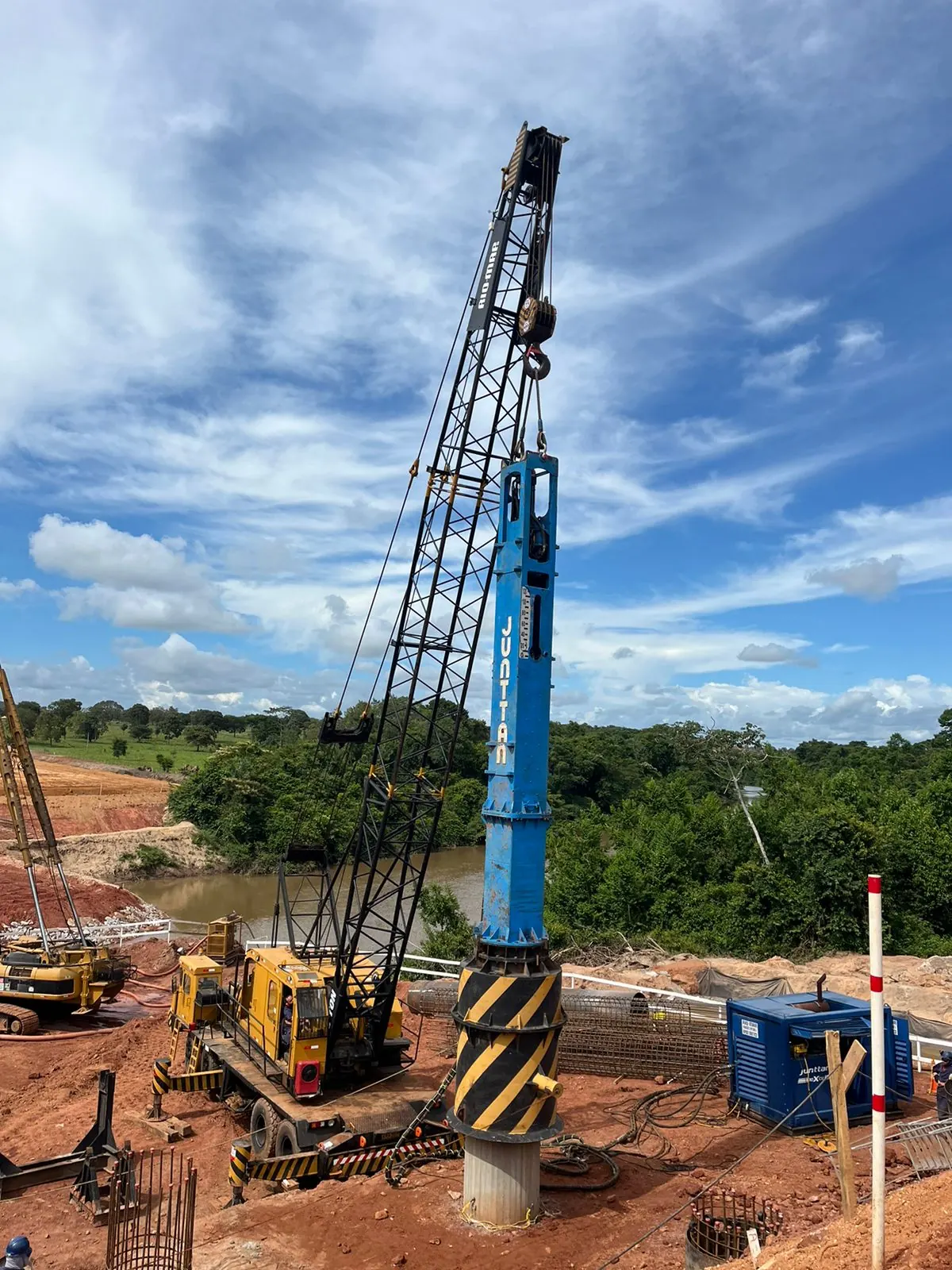 Large hydraulic hammer being used in PDA testing for infrastructure project foundations.